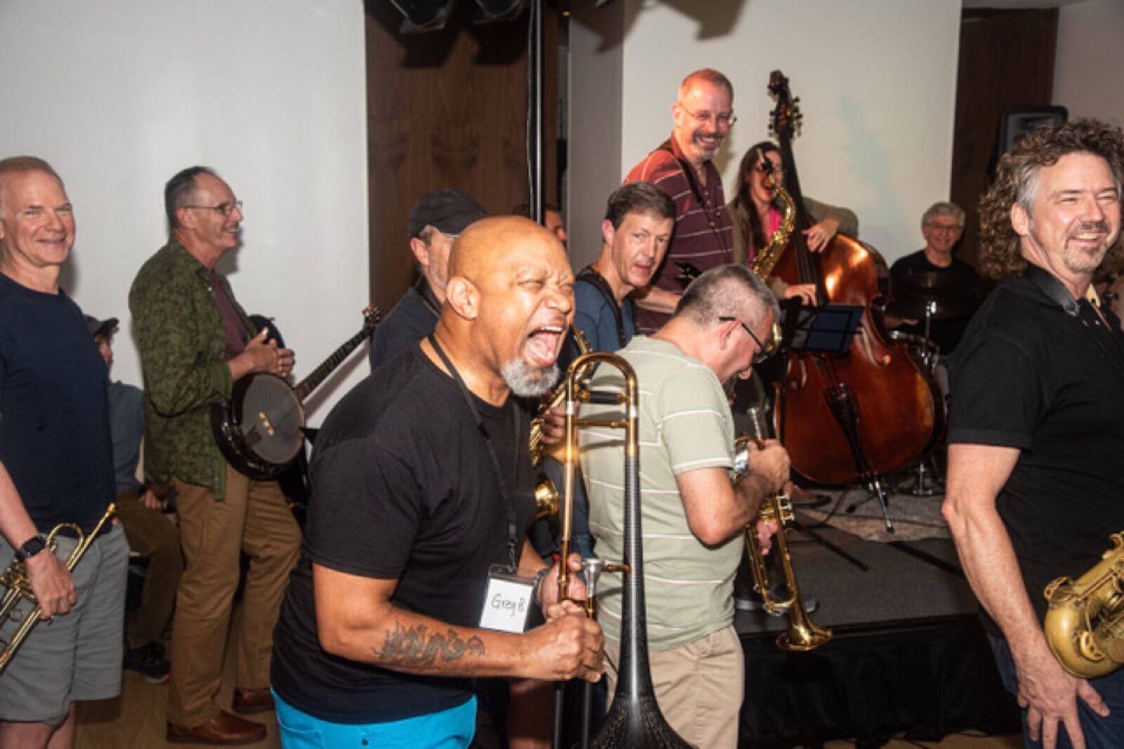 Adult musicians laughing and playing together on stage at a JazzWire Summit